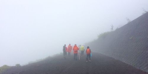 Woman standing in foggy weather