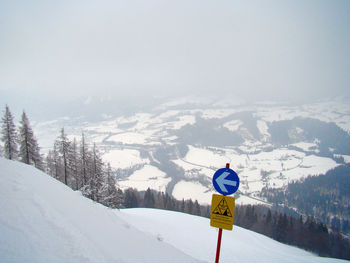 Snow covered mountain road against sky