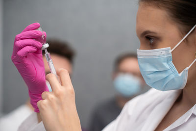 Midsection of dentist examining patient at clinic