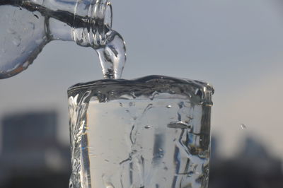 Close-up of glass pouring water