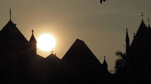 Low angle view of church against sky at sunset