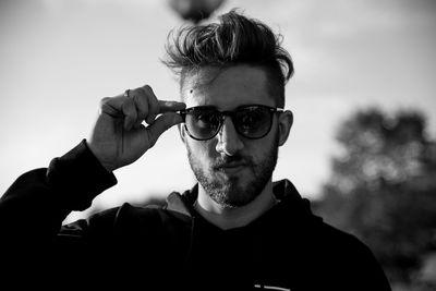 Young man against sky