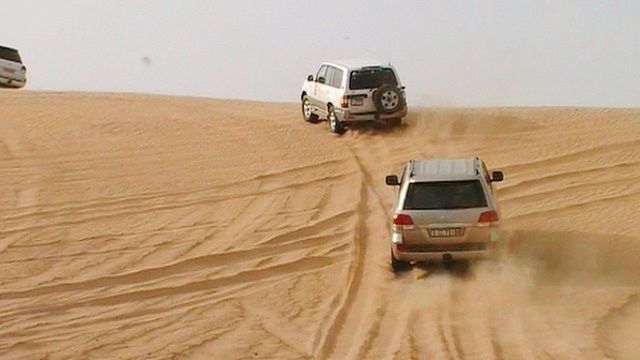 car, land vehicle, transportation, mode of transport, landscape, on the move, travel, journey, desert, sand dune, dirt road, off-road vehicle, moving, vehicle, rippled, dirt, arid climate, outdoors, dust, van, day, 4x4, horizon over land, remote, non urban scene, non-urban scene, tranquility, scenics