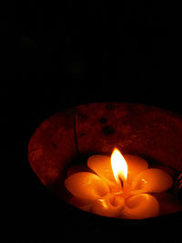 Close-up of illuminated lamp over black background