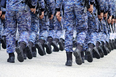 Low section of armed forces walking outdoors