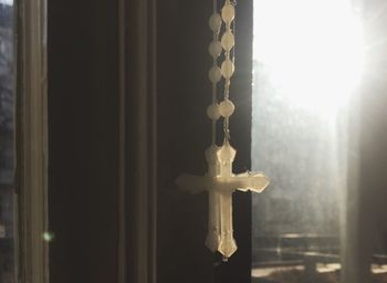 Close-up of cross against sky