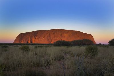 Scenic view of rock formation against sky during sunset