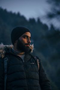 Side view of man standing against sky