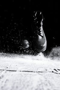 Close-up of black shoes in water