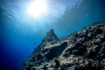 Low angle view of sea against blue sky