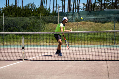 Full length of man playing tennis