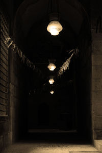 Low angle view of illuminated pendant light hanging from ceiling