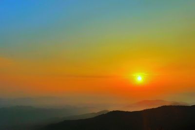 Scenic view of silhouette mountain against romantic sky at sunset