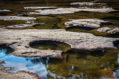 Riverbed stone hole naturally formed with water from top angle