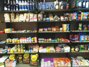 Multi colored bottles in shelf at store