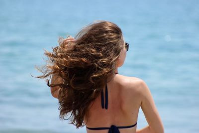 Rear view of woman against sea