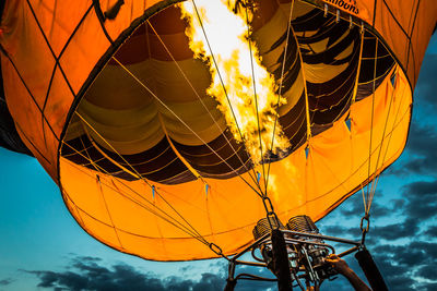 Low angle view of fire burning in hot air balloon at dusk