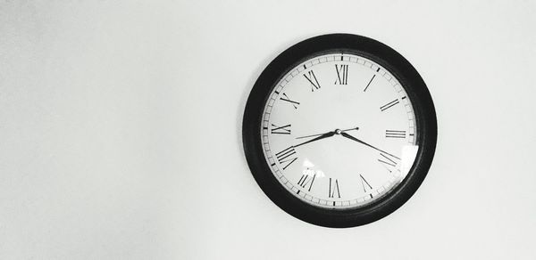 Low angle view of clock on wall