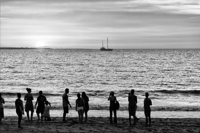 People on beach against sky