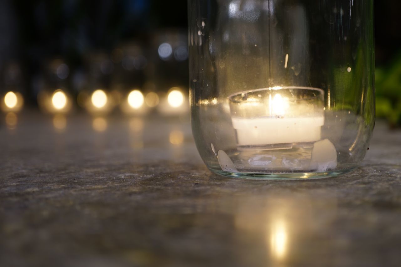 selective focus, table, glass - material, close-up, no people, transparent, indoors, nature, still life, drink, glass, illuminated, drinking glass, lighting equipment, reflection, household equipment, wood - material, day, surface level