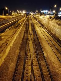 Railway tracks against sky at night