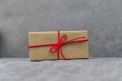 Close-up of red box tied on table