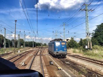 Railroad tracks seen through train windshield