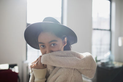 A young woman wearing a hat and robe