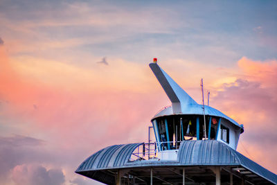 Low angle view of tower against cloudy sky