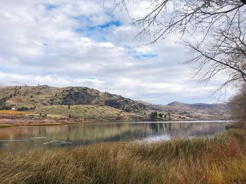 Scenic view of lake against cloudy sky