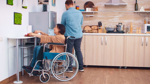 Rear view of man working at home