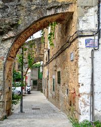 Empty alley amidst buildings in city