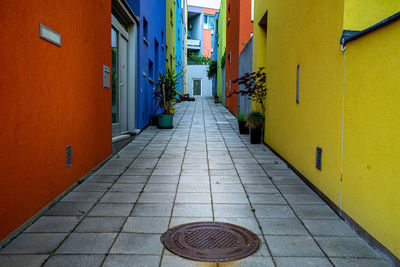 Empty alley amidst buildings in city