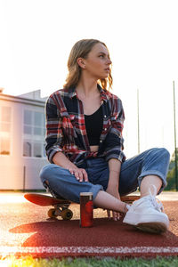 Portrait of a young woman sitting outdoors