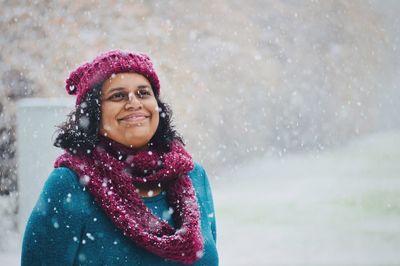 Portrait of smiling young woman in snow