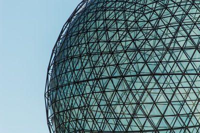 Low angle view of modern building against clear blue sky