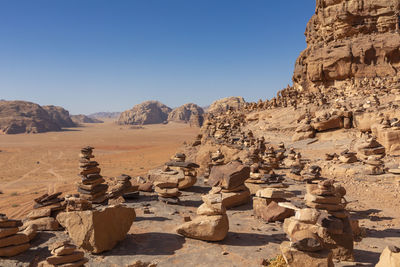 View of rocks and mountains against clear sky