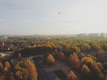 High angle view of trees and buildings against sky