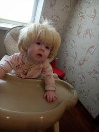 Portrait of cute baby girl in bathroom