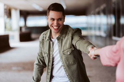 Portrait of smiling young man standing outdoors