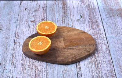 High angle view of orange slice on cutting board