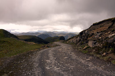 Road amidst mountains against sky