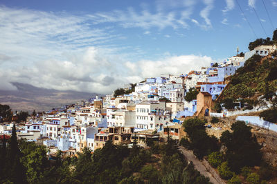 High angle view of buildings in town against sky
