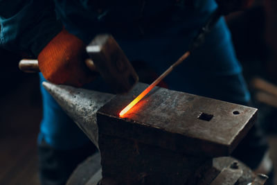 Midsection of man working in workshop