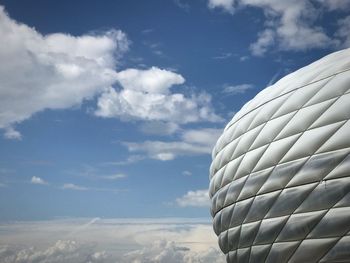 Low angle view of white balloons flying against sky