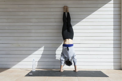 Young asian woman doing yoga in the sun