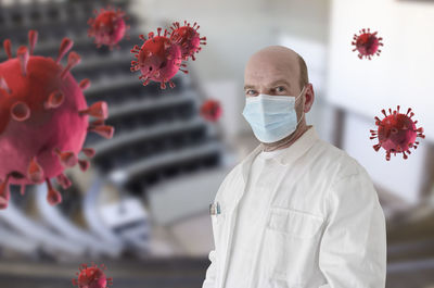 Portrait of man standing by flowers