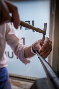 Midsection of carpenter working at workshop