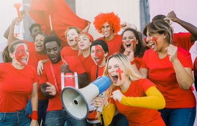 Young people having fun outside the stadium after sport event