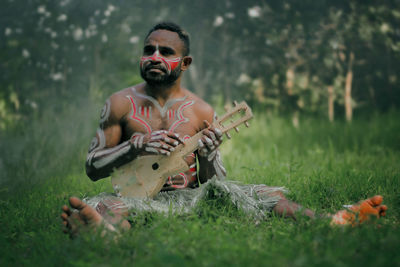 Man sitting on field